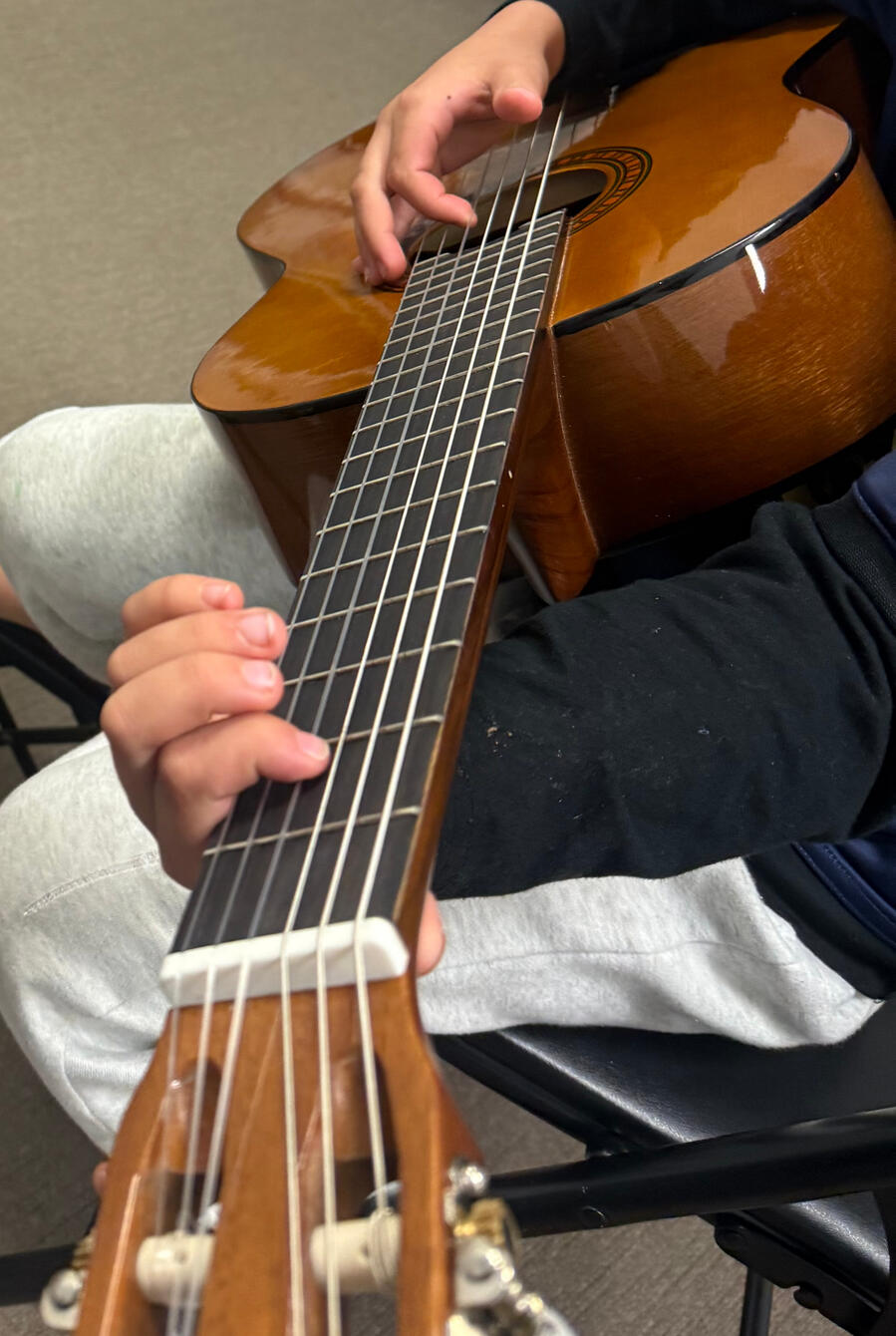 Student learning classical guitar at Major Music Studio